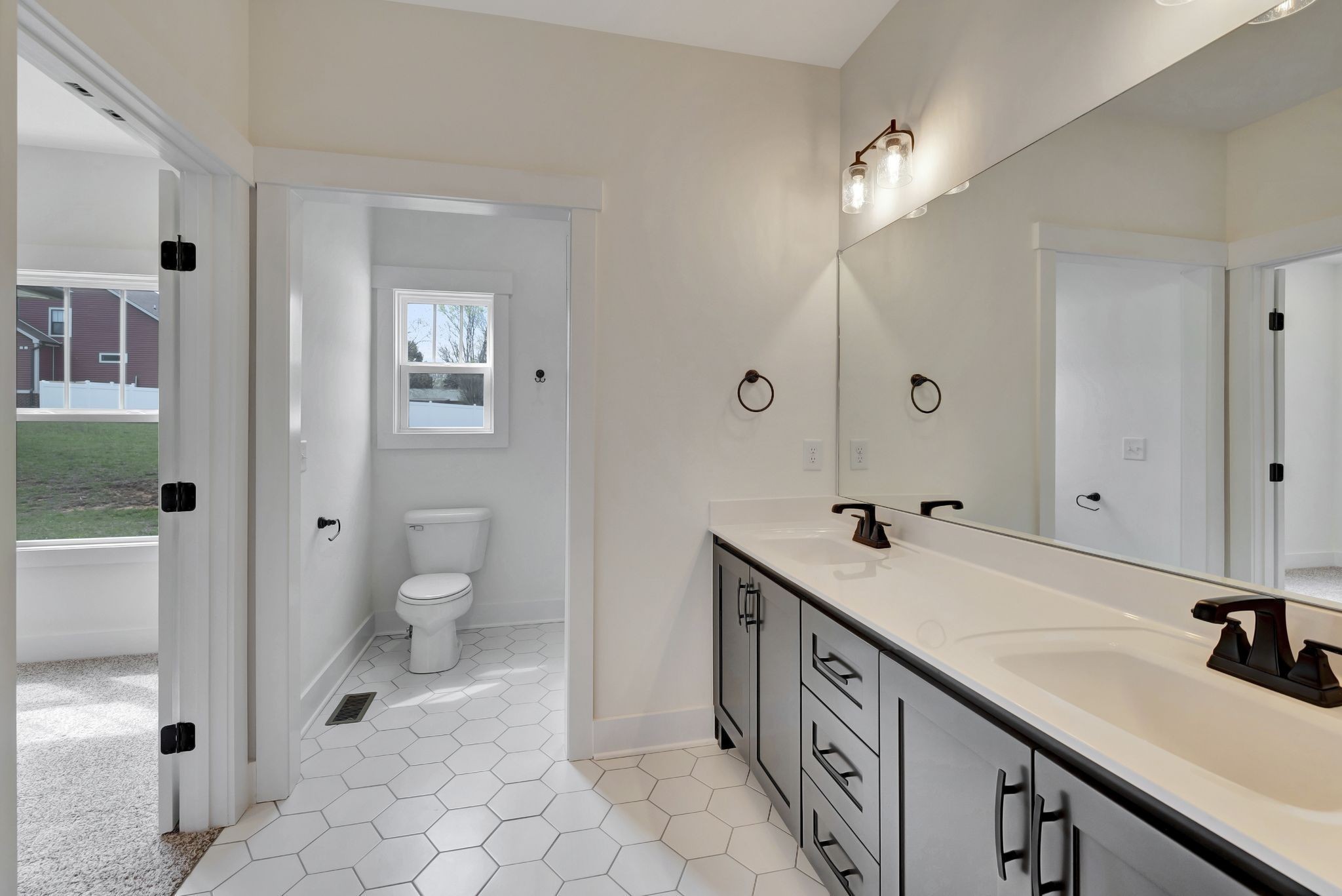 1038 Camden Trail Greenbrier, TN 37073 - Photo 21 of 36 a spacious bathroom with a double vanity sink a toilet and a mirror