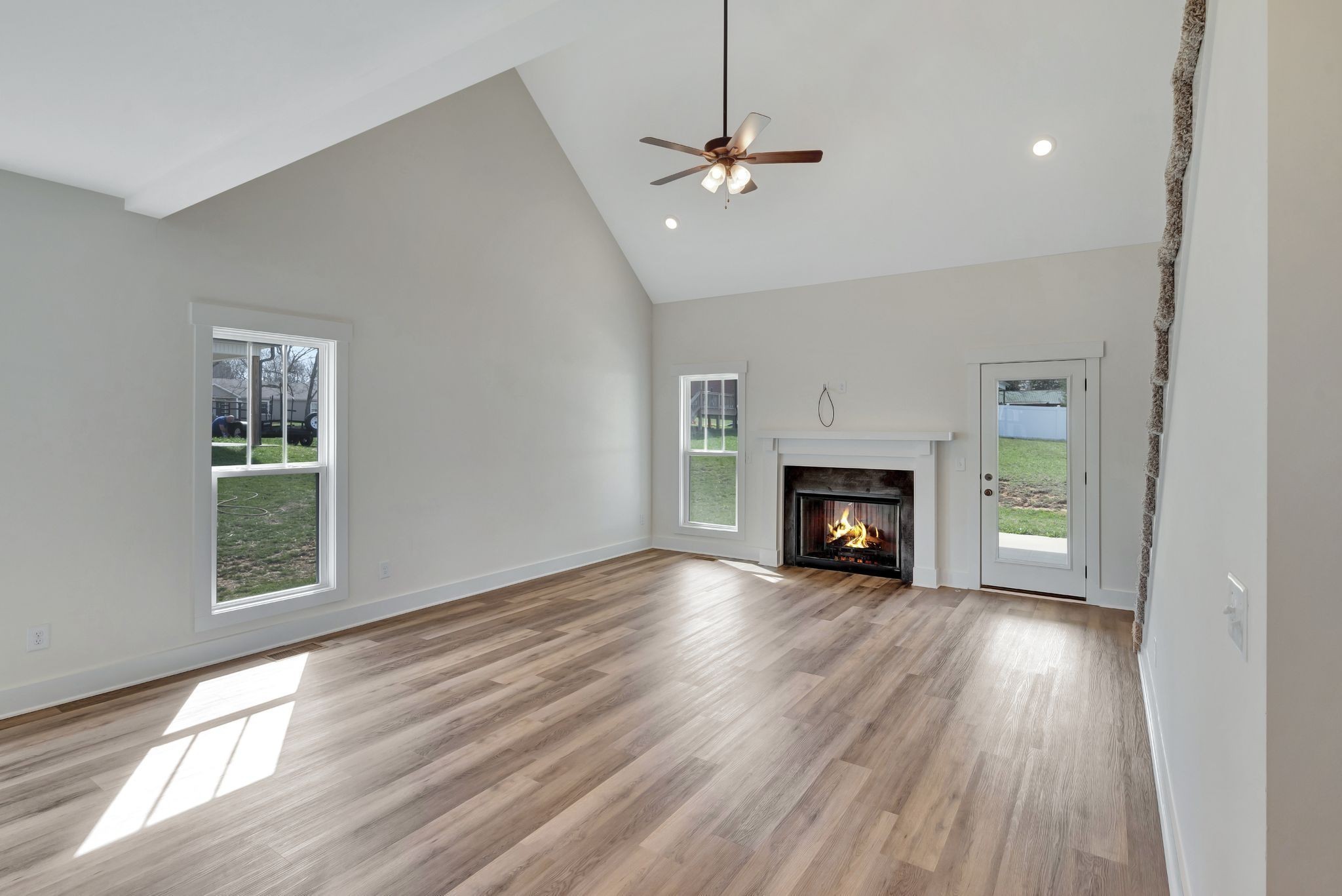 1038 Camden Trail Greenbrier, TN 37073 - Photo 6 of 36 a view of an empty room with wooden floor fireplace and a window