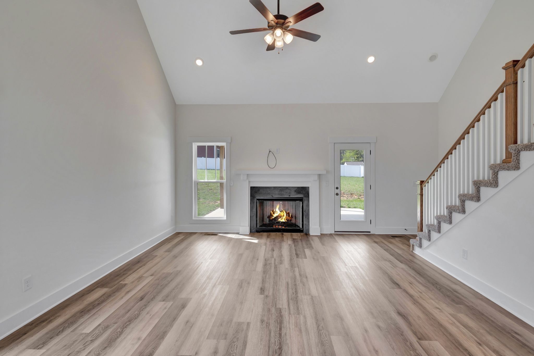 1038 Camden Trail Greenbrier, TN 37073 - Photo 7 of 36 a view of an empty room with a fireplace and a window
