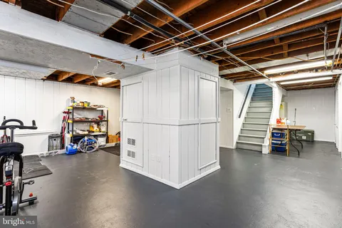 a view of storage and utility room with stairs and a way to kitchen