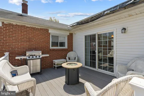 a view of a patio with table and chairs and barbeque