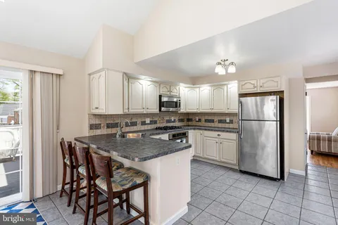 a kitchen with a refrigerator a sink and a stove
