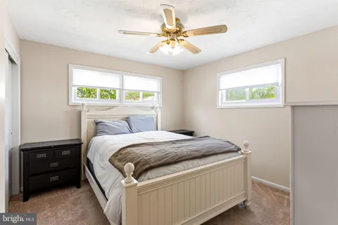 a bed sitting in a bedroom next to a window
