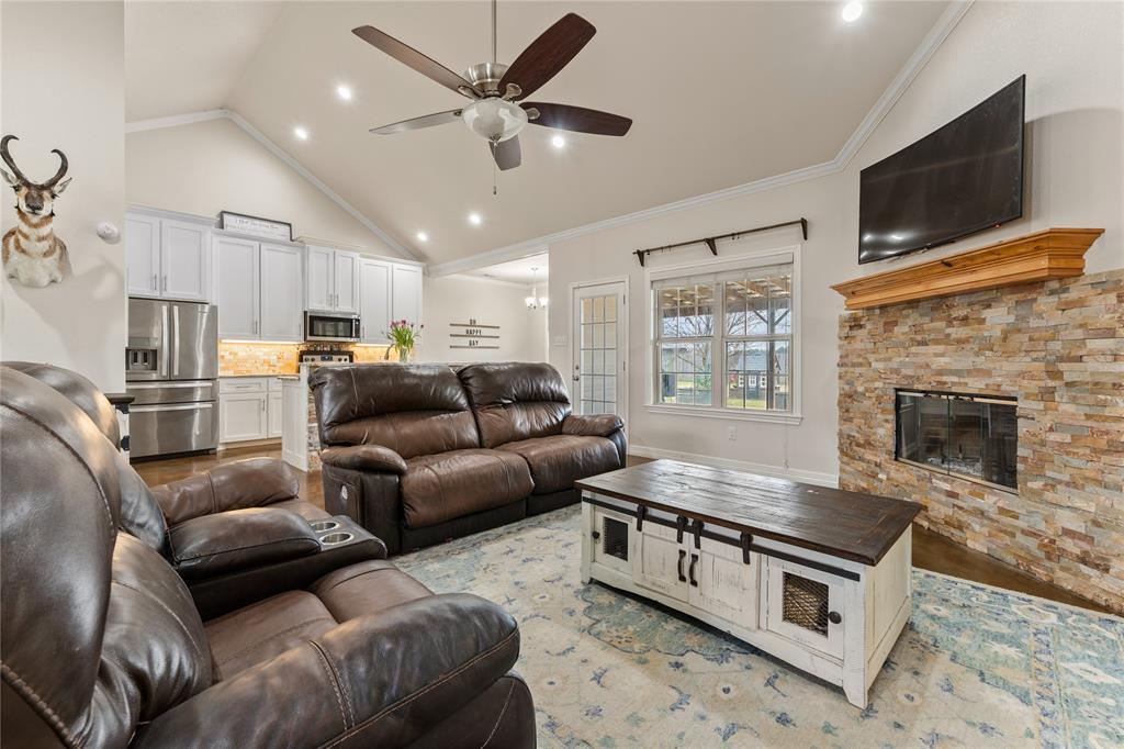 10514 Mesa Drive Waco, TX 76708 - Photo 11 of 39 Living area with light wood-style floors, a fireplace, crown molding, recessed lighting, and a ceiling fan