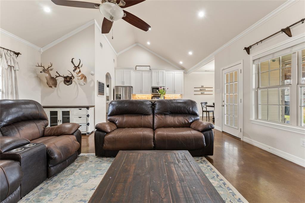 10514 Mesa Drive Waco, TX 76708 - Photo 12 of 37 Living room with concrete flooring, recessed lighting, ornamental molding, high vaulted ceiling, and arched walkways