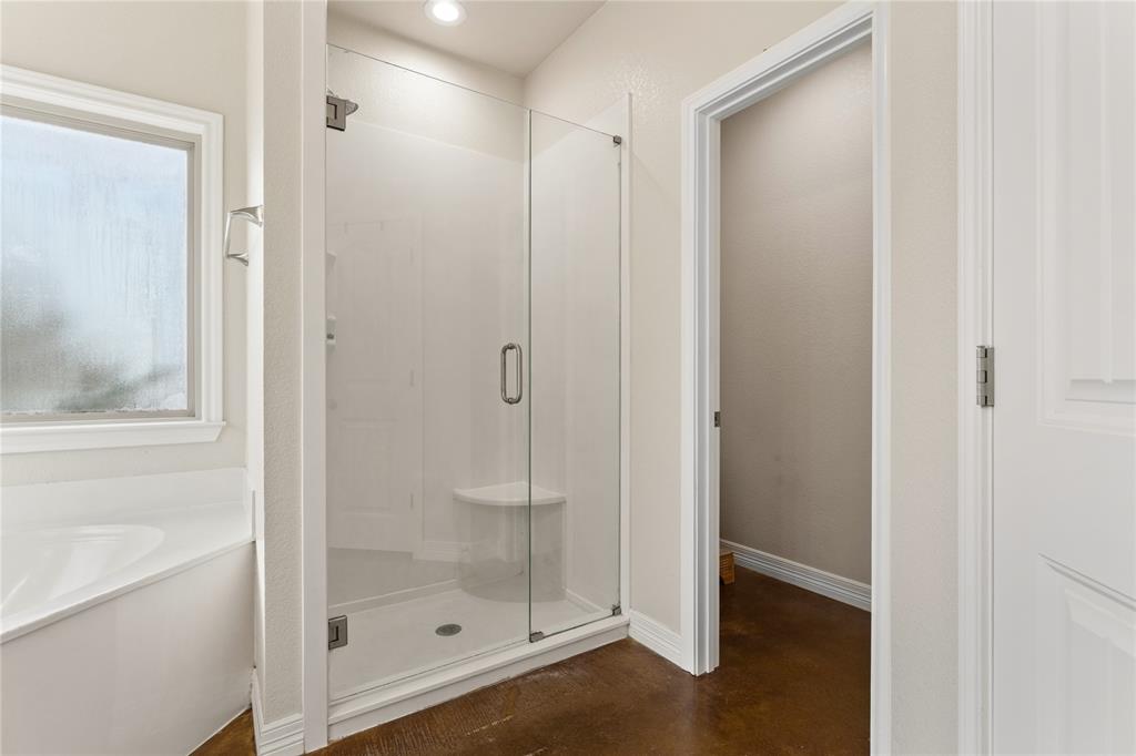 10514 Mesa Drive Waco, TX 76708 - Photo 28 of 37 Full bath with a stall shower, a garden tub, and finished concrete floors
