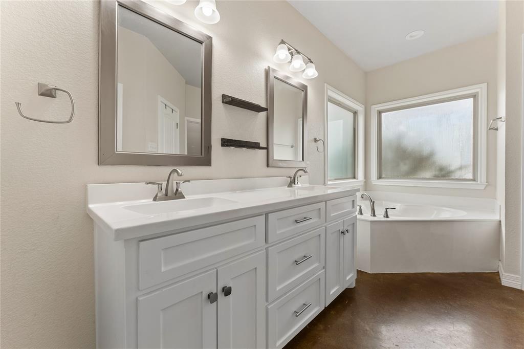 10514 Mesa Drive Waco, TX 76708 - Photo 30 of 37 Full bathroom with double vanity, a garden tub, concrete flooring, and a textured wall