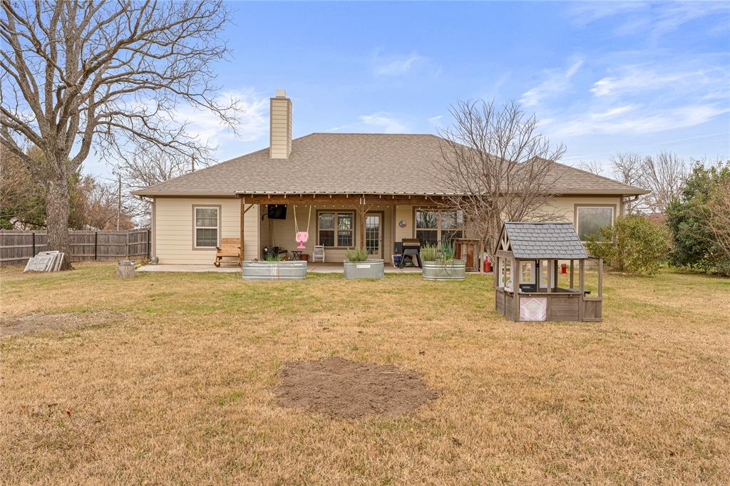 10514 Mesa Drive Waco, TX 76708 - Photo 35 of 39 Back of property featuring a chimney, a patio, and roof with shingles