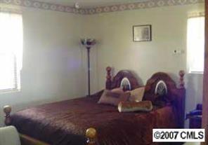 2204 George Brown Road Crouse, NC 28033 - Photo 7 of 8 a bedroom with bed and wooden floor