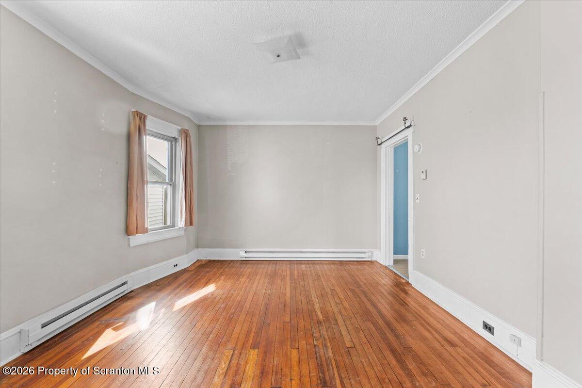 715 Alder Street Scranton, PA 18505 - Photo 15 of 38 an empty room with wooden floor and windows
