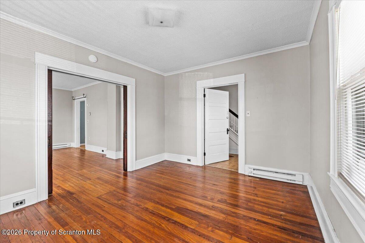 715 Alder Street Scranton, PA 18505 - Photo 16 of 38 an empty room with wooden floor and windows