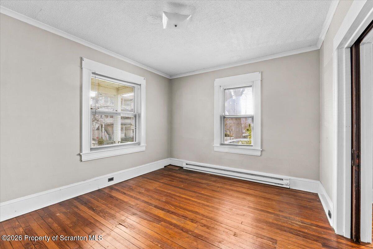 715 Alder Street Scranton, PA 18505 - Photo 17 of 38 a view of an empty room with wooden floor and a window