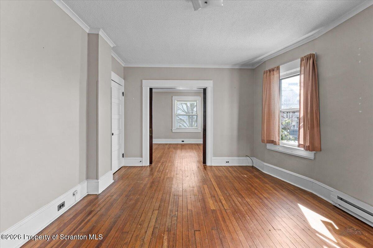 715 Alder Street Scranton, PA 18505 - Photo 18 of 38 a view of an empty room with window and wooden floor
