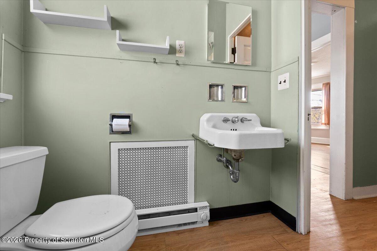 715 Alder Street Scranton, PA 18505 - Photo 19 of 38 a bathroom with a sink a toilet and mirror