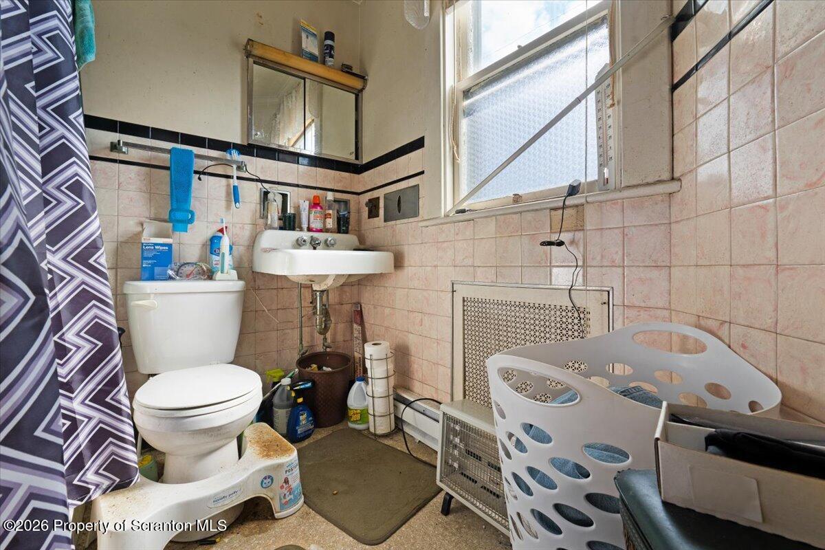 715 Alder Street Scranton, PA 18505 - Photo 21 of 38 a bathroom with a sink toilet and a mirror