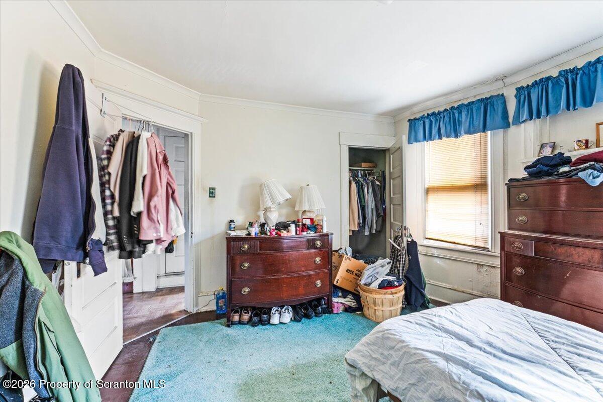 715 Alder Street Scranton, PA 18505 - Photo 29 of 38 a bedroom with a bed and a walk in closet
