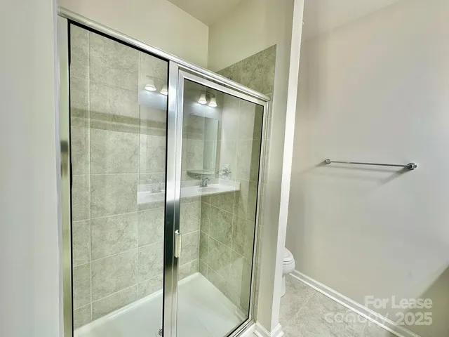 a bathroom with a glass shower door