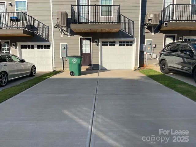 a view of a car park in front of house
