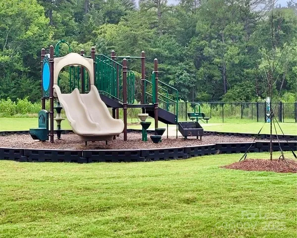 a view of a swimming pool with a patio and a yard