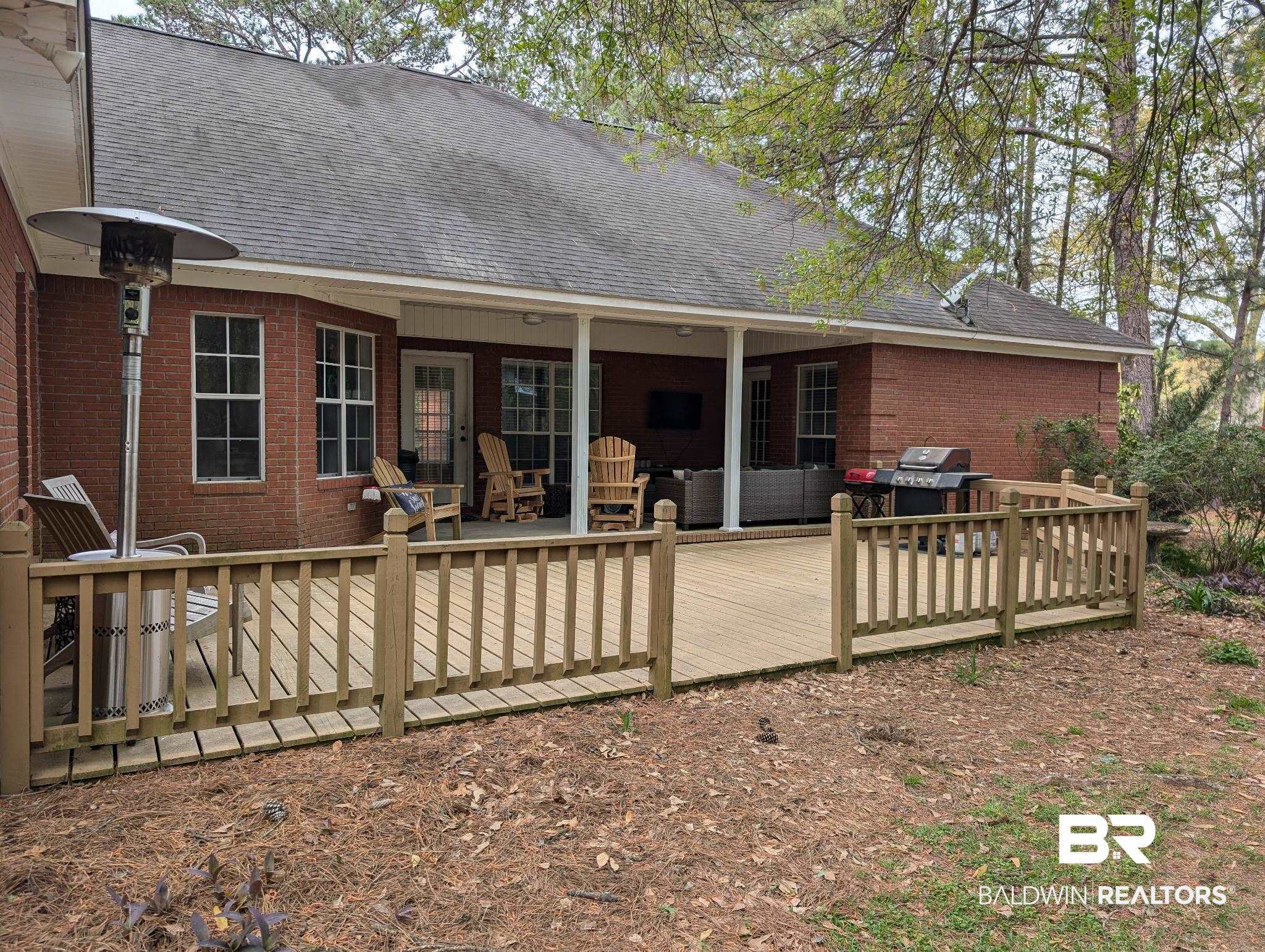 506 Old Castleberry Road Brewton, AL 36426 - Photo 13 of 14 Rear view of house featuring a shingled roof, a deck, and brick siding