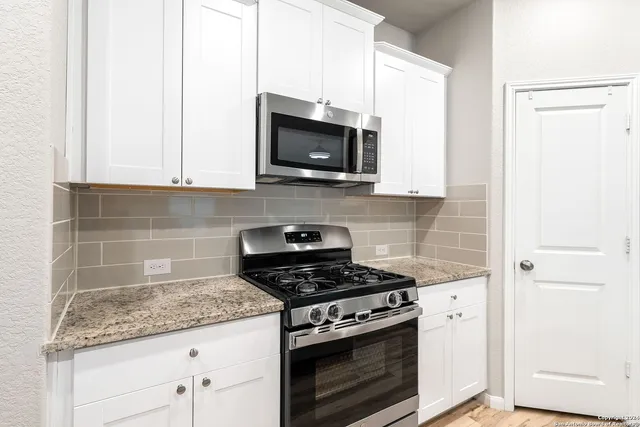 a kitchen with granite countertop a sink and a granite top
