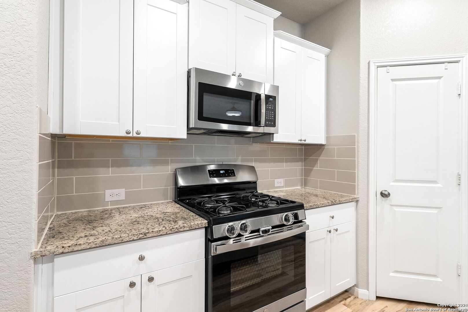 10535 Margarita Loop Converse, TX 78109 - Photo 13 of 51 a kitchen with stainless steel appliances granite countertop white cabinets and a stove