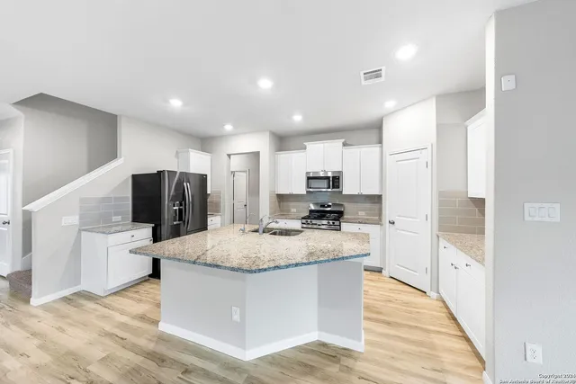 a living room with furniture a window and wooden floor