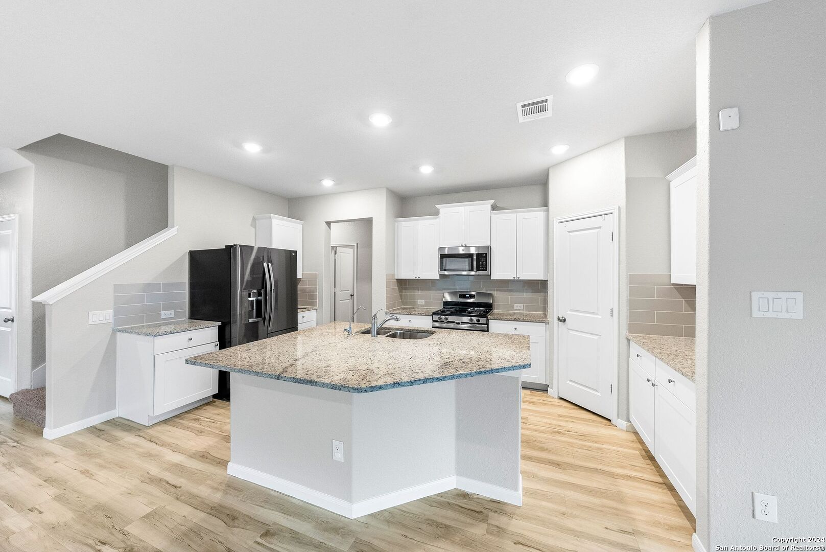 10535 Margarita Loop Converse, TX 78109 - Photo 15 of 51 a large kitchen with kitchen island a counter top space a sink appliances and cabinets