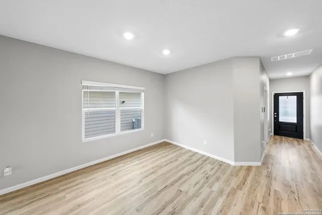 a view of kitchen with wooden floor and electronic appliances