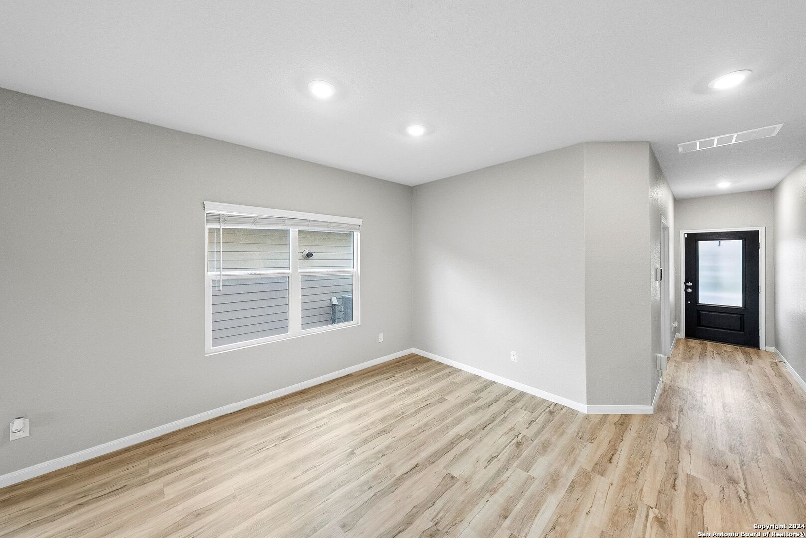 10535 Margarita Loop Converse, TX 78109 - Photo 17 of 51 a view of an empty room with wooden floor and a window