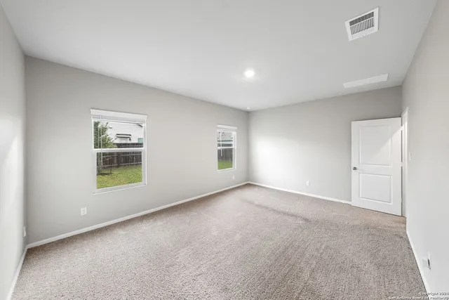 a spacious bathroom with a granite countertop sink a mirror and shower