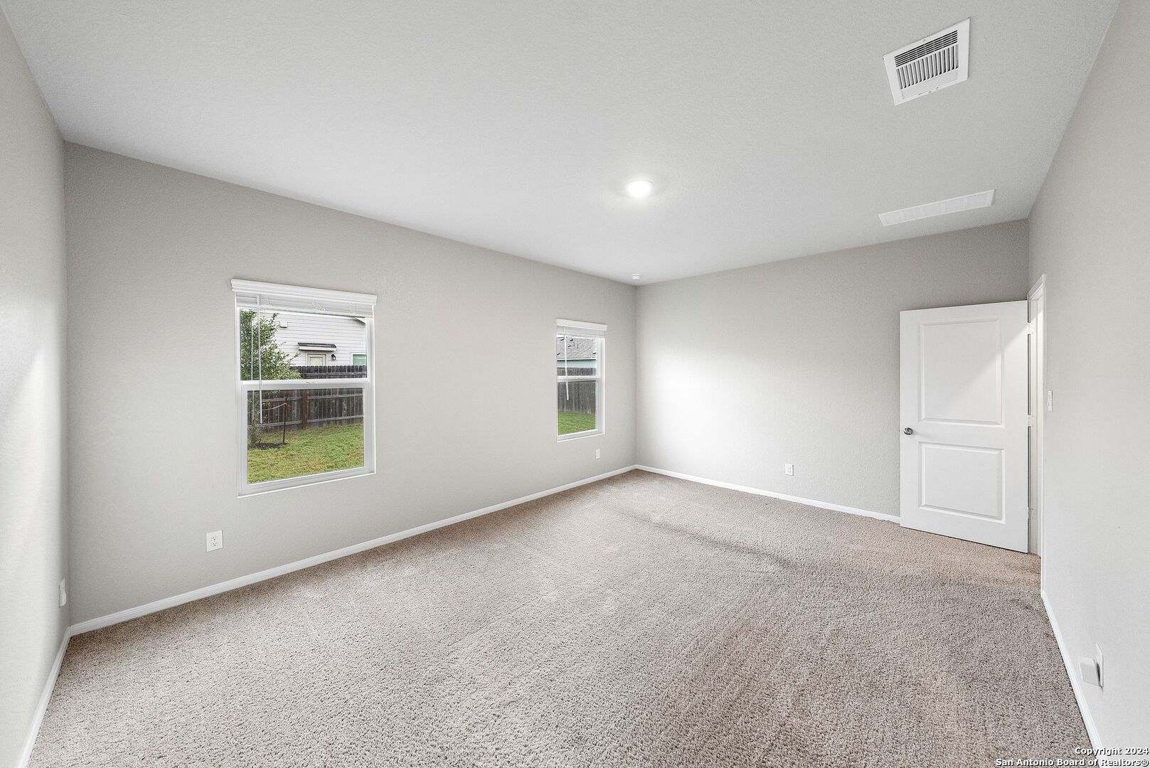 10535 Margarita Loop Converse, TX 78109 - Photo 22 of 51 an empty room with a fireplace and windows