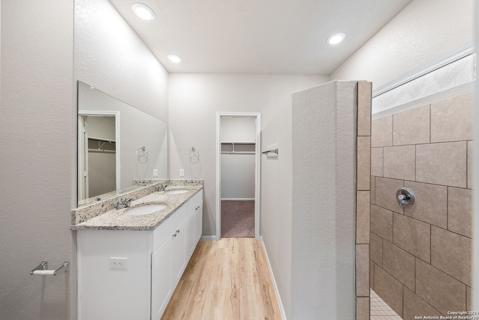 10535 Margarita Loop Converse, TX 78109 - Photo 23 of 51 a spacious bathroom with a granite countertop sink a mirror and shower
