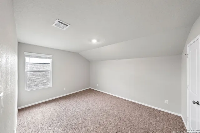 a view of an empty room and a window