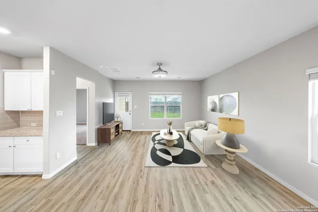 wooden floor in an empty room with a window