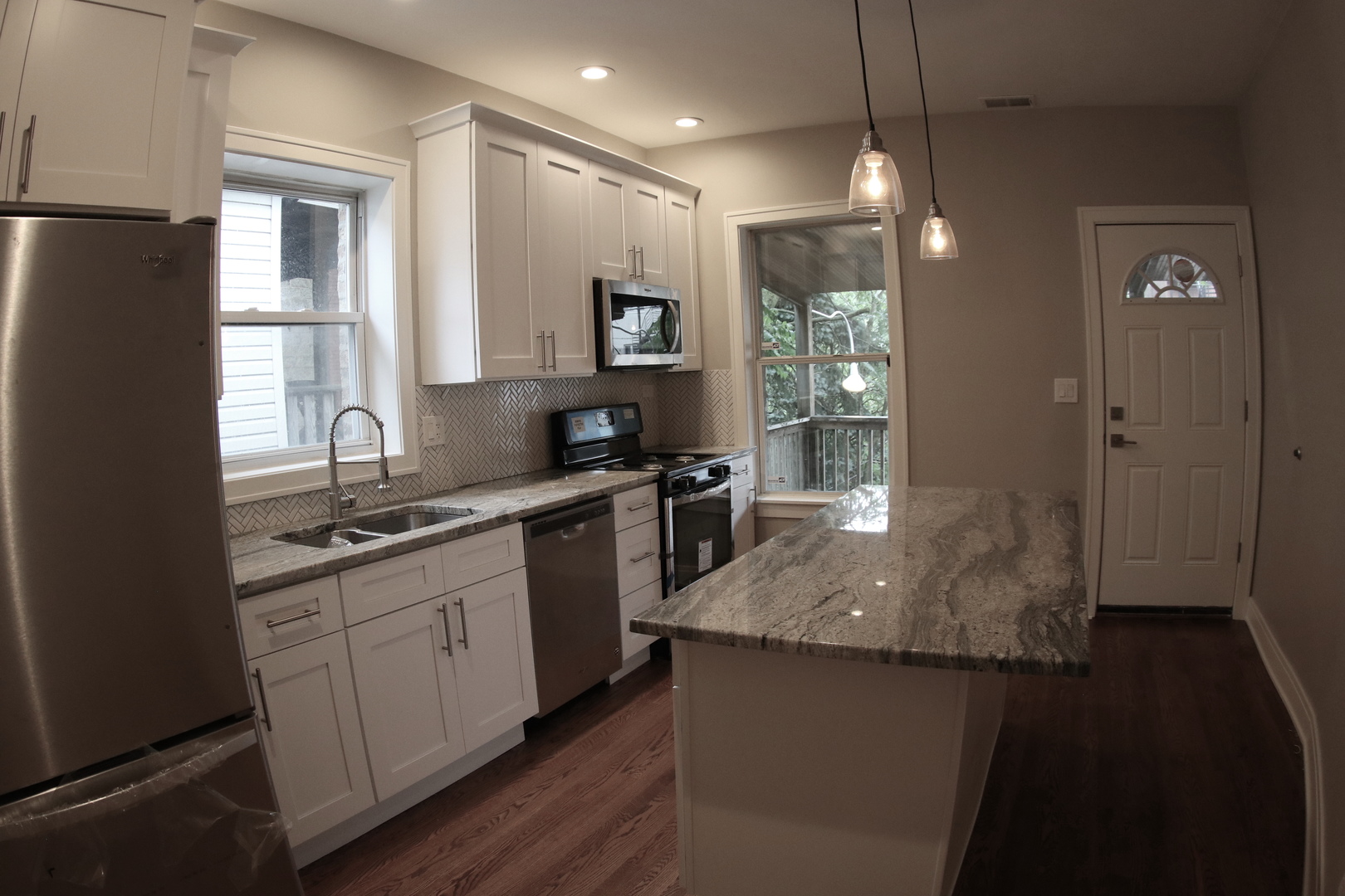 1307 West Fillmore Street Chicago, IL 60607 - Photo 31 of 42 a large kitchen with granite countertop a sink and dishwasher a stove top oven with wooden floor