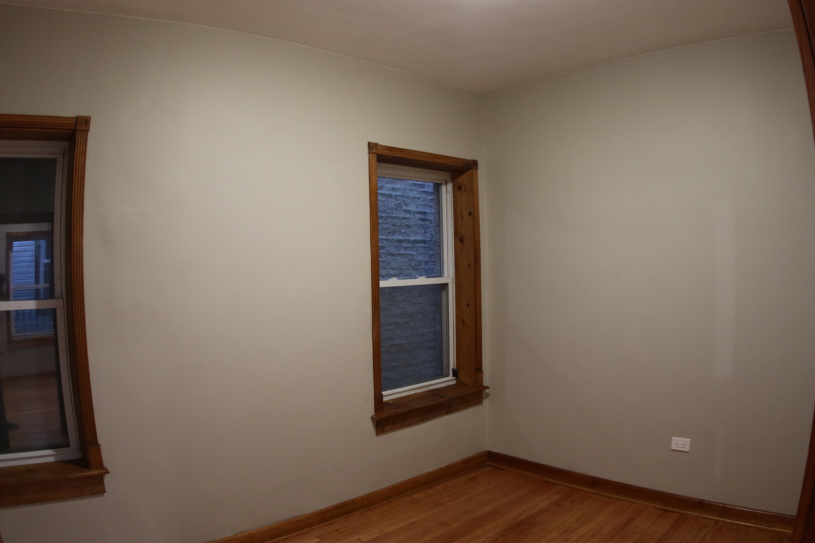 1307 West Fillmore Street Chicago, IL 60607 - Photo 5 of 42 a view of an empty room with wooden floor and a window