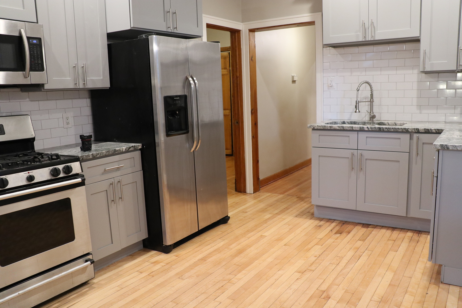 1307 West Fillmore Street Chicago, IL 60607 - Photo 6 of 42 a kitchen with stainless steel appliances granite countertop a refrigerator stove and sink