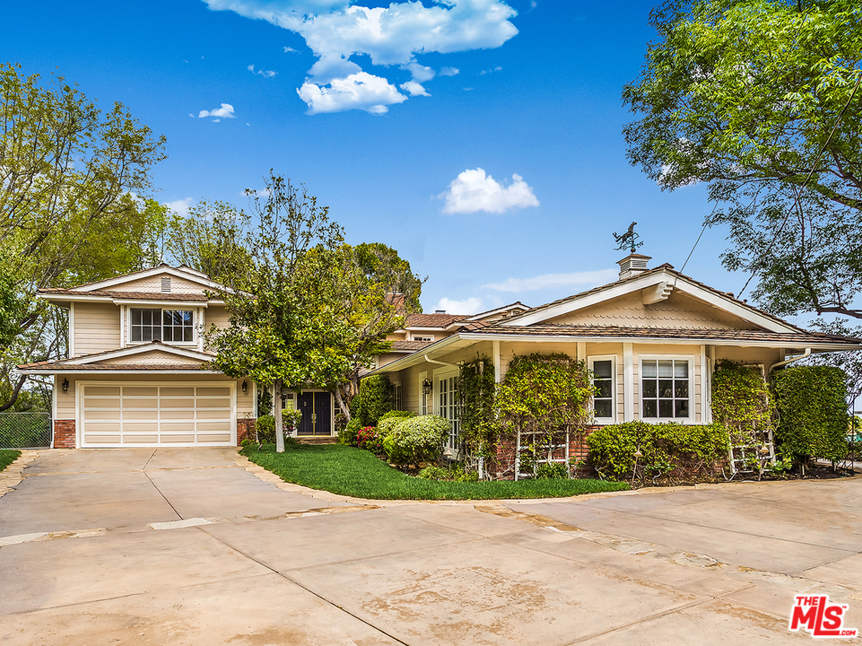 24835 Jacob Hamblin Road Hidden Hills, CA 91302 - Photo 1 of 29 a front view of a house with a yard and a garden