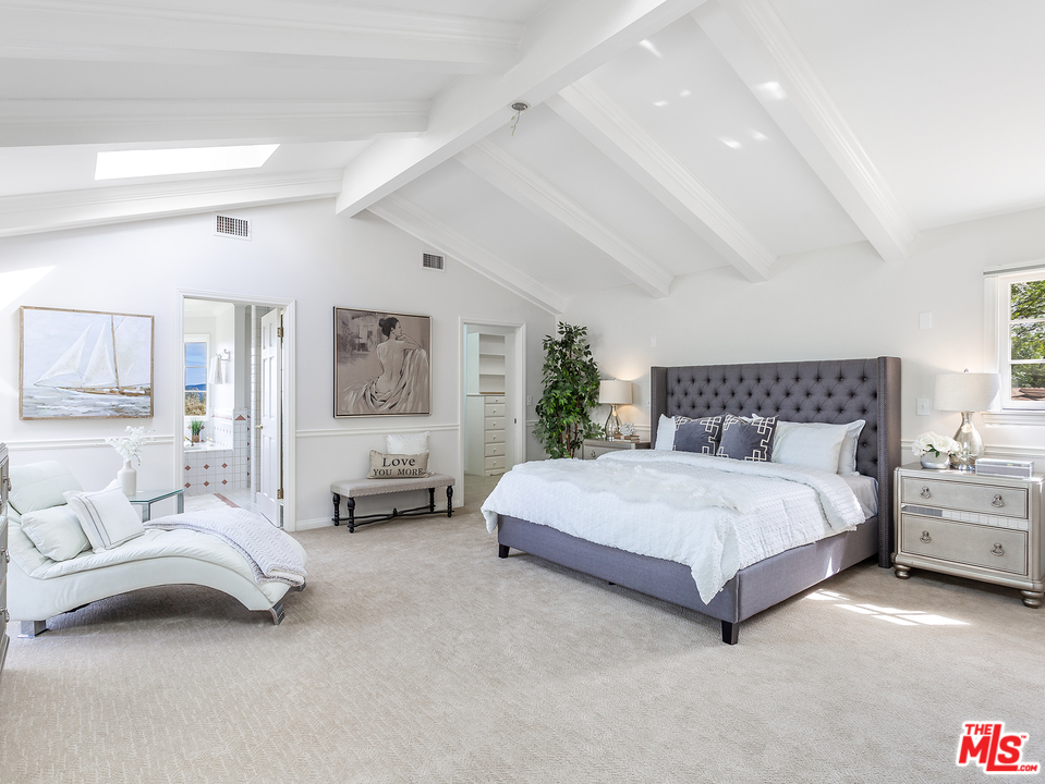 24835 Jacob Hamblin Road Hidden Hills, CA 91302 - Photo 11 of 29 a spacious bedroom with a bed and a couch