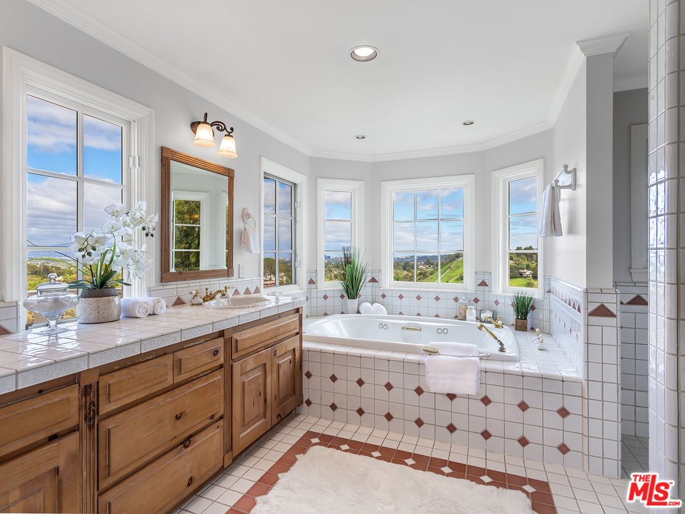 24835 Jacob Hamblin Road Hidden Hills, CA 91302 - Photo 12 of 29 a bathroom with a double vanity sink mirror double vanity