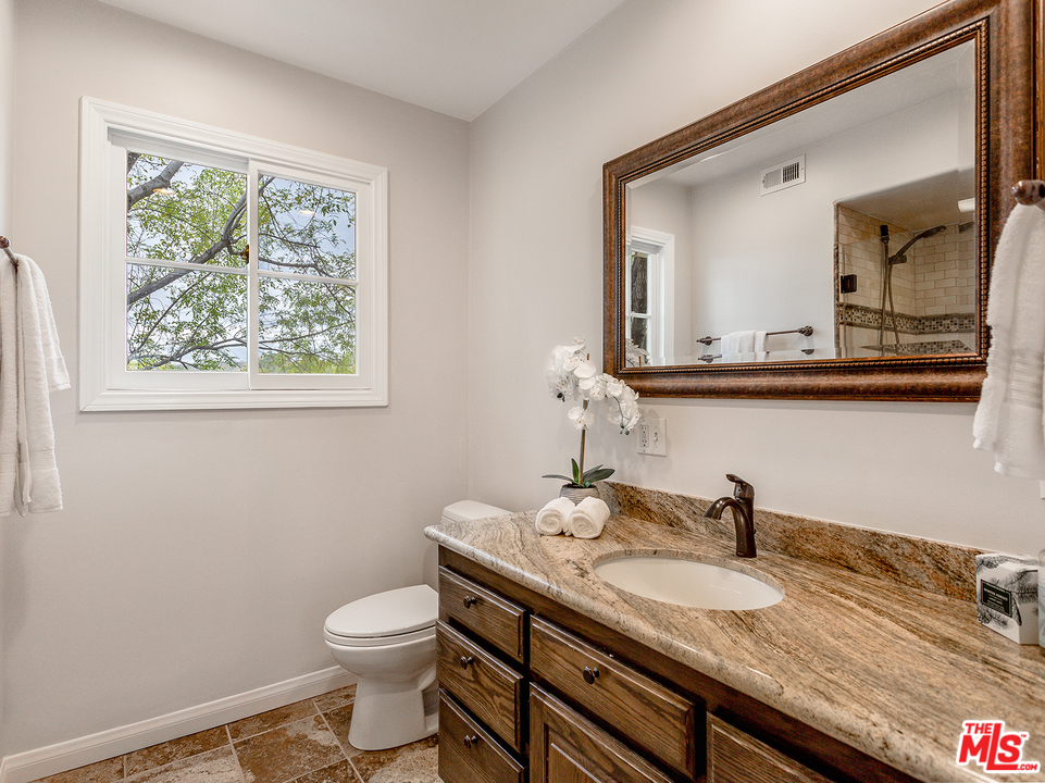 24835 Jacob Hamblin Road Hidden Hills, CA 91302 - Photo 14 of 29 a bathroom with a granite countertop sink and a toilet