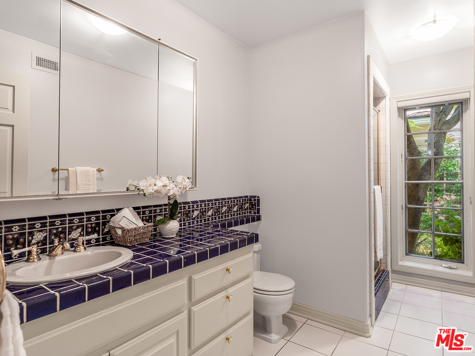 24835 Jacob Hamblin Road Hidden Hills, CA 91302 - Photo 20 of 29 a bathroom with a granite countertop sink and a toilet