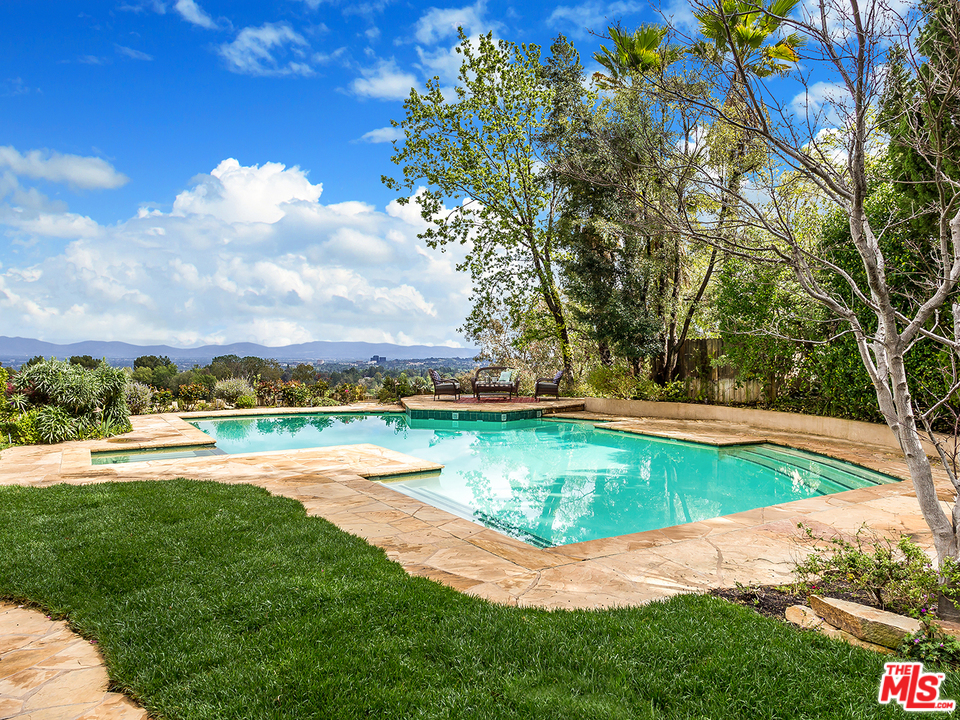 24835 Jacob Hamblin Road Hidden Hills, CA 91302 - Photo 23 of 29 a view of a swimming pool with an ocean view