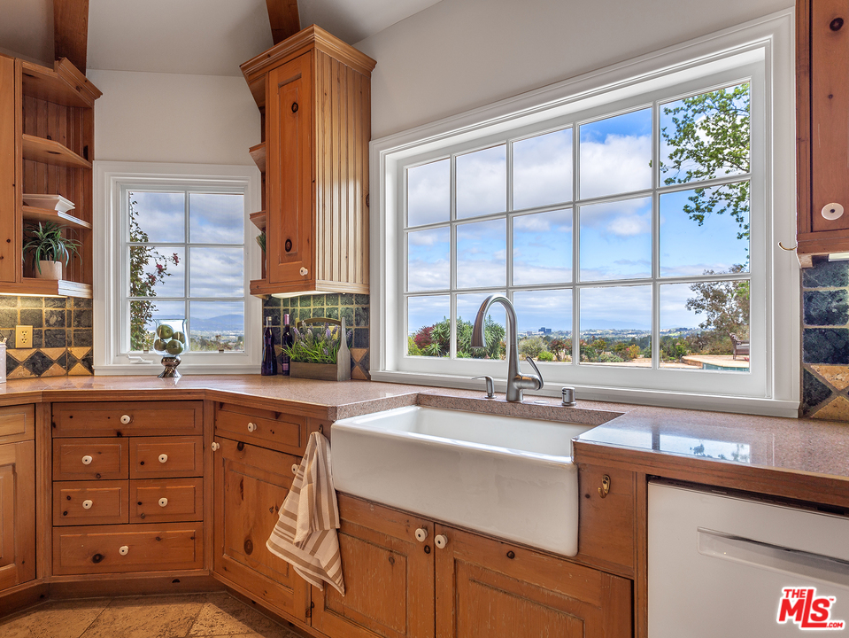 24835 Jacob Hamblin Road Hidden Hills, CA 91302 - Photo 4 of 29 an open kitchen with a sink and large window