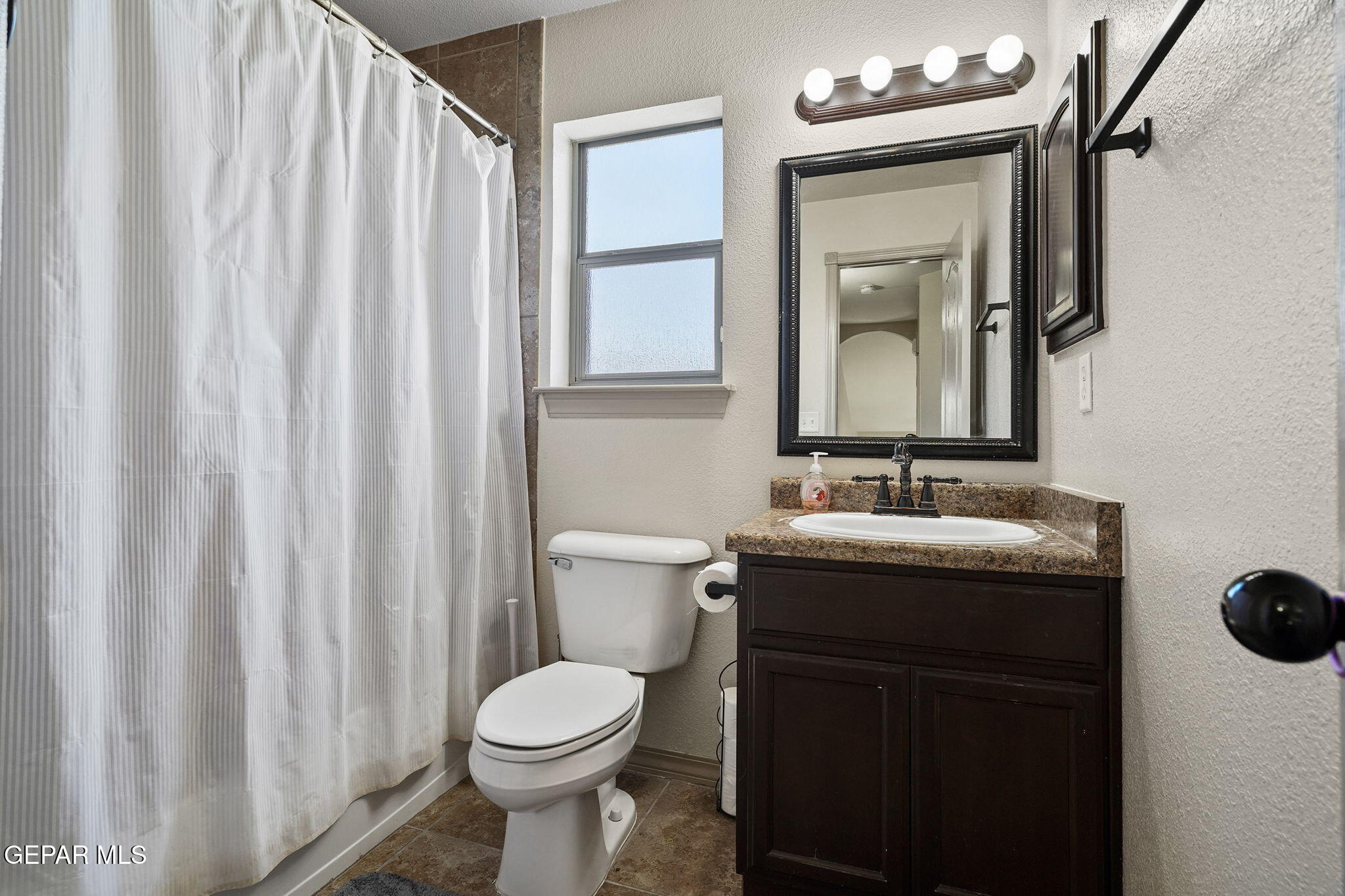 3152 Rustic Hidden Drive El Paso, TX 79938 - Photo 26 of 38 a bathroom with a toilet sink and mirror