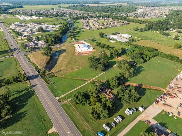an aerial view of a residential houses with outdoor space and river