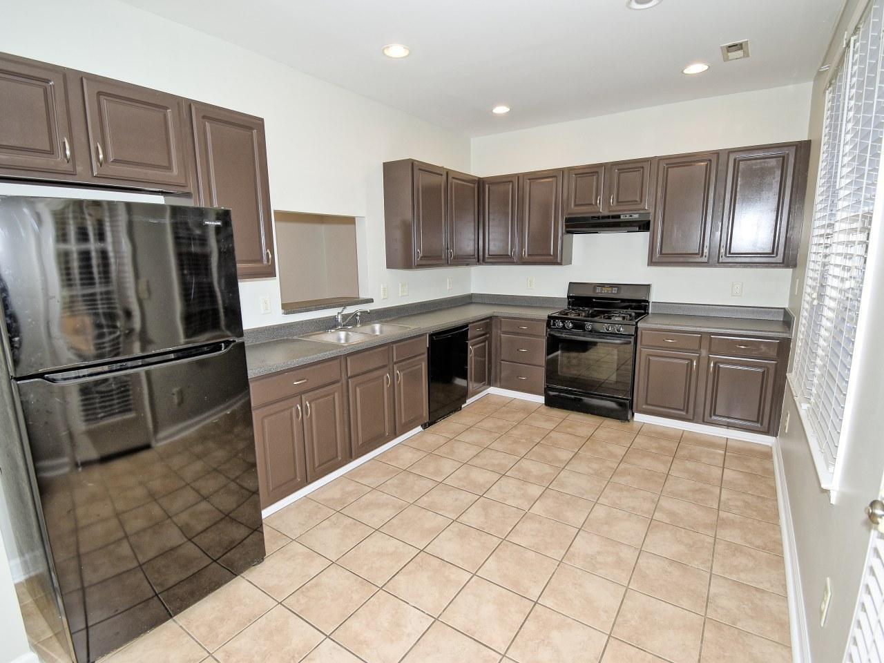 2245 Long Pine Lane Raleigh, NC 27603 - Photo 11 of 33 a kitchen with stainless steel appliances granite countertop a stove top oven a sink dishwasher a refrigerator and cabinets