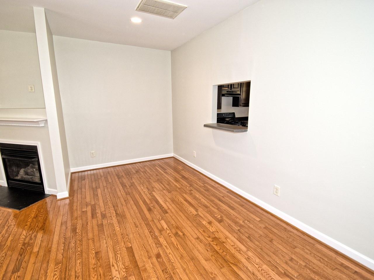 2245 Long Pine Lane Raleigh, NC 27603 - Photo 6 of 33 a view of an empty room with wooden floor and a fireplace