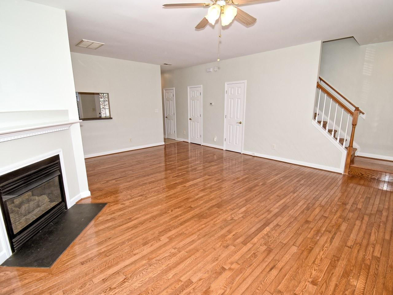 2245 Long Pine Lane Raleigh, NC 27603 - Photo 7 of 33 a view of an empty room with wooden floor fireplace and a window
